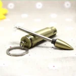 Close-up of metal striker rod being pulled from brass bullet lighter