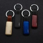 Mini keychain lighters in gold black blue and maroon with leather loops