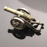 Close-up of the detailed metal cannon barrel and wheels on the lighter